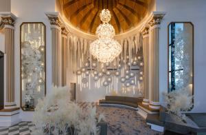 a large lobby with a large chandelier and a couch at Arte Cheras Designer Suite by Moka @ Cheras in Kuala Lumpur