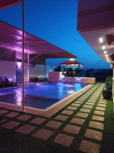 a swimming pool in a building at night at استراحة الساحل in Dumistān