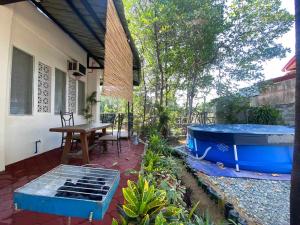 a small patio with a hot tub and a table at Rio Vista Bed and Breakfast in Dagupan