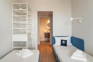 a small room with two beds and a closet at Palazzo Verdi Luxury Accomodation in Bari