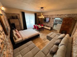 a living room with a couch and a dining room at Casa Armoniei in Baia Mare