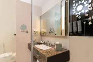 a bathroom with a sink and a mirror at Courtyard by Marriott Agra in Agra