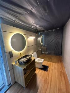 a bathroom with a sink and a toilet in a room at Chitragarh Farm in New Delhi