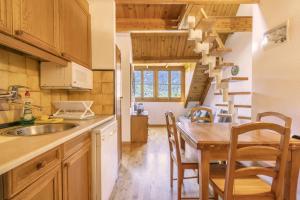 a kitchen with a wooden table and a dining room at La Cabanyeta de la Vall de Boí in Pla de l'Ermita