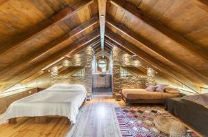 a attic room with two beds and a couch at Turdus Merula Retreat in Nea Makri +88 photos