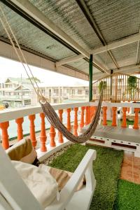 a hammock on the balcony of a house at Pallet Homes - Ledesco in Iloilo City