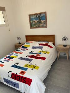 a bed with a comforter with the words oops dream on it at Grand T2 climatisé a 5 min de la gare st-charles - vieux port in Marseille