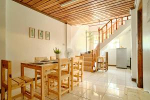 a dining room with a wooden table and chairs at Pallet Homes - Ledesco in Iloilo City