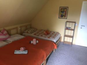 a bedroom with two beds and a ladder at Haus KAIROS in Spittal an der Drau