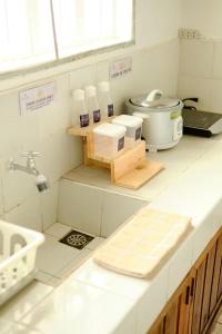a kitchen with a counter with a sink and a mixer at Pallet Homes - Ledesco in Iloilo City
