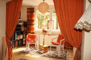 a living room with two chairs and a window at Haus KAIROS in Spittal an der Drau