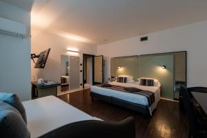 Postel nebo postele na pokoji v ubytování Hotel Buonconsiglio