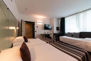 Postel nebo postele na pokoji v ubytování Hotel Buonconsiglio