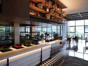 a restaurant with a counter with bowls on it at Sheraton Xuzhou in Xuzhou