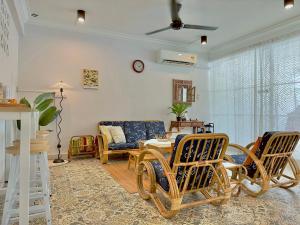 a living room with chairs and a couch at NewWALAI N3 Landed house near IMAGO KK with CarGarage in Kota Kinabalu