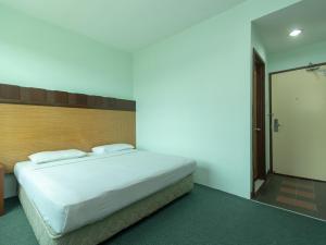 Postel nebo postele na pokoji v ubytování Royal Hotel