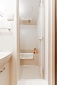 a small bathroom with a sink and a shower at 川HOUSE旭 in Osaka