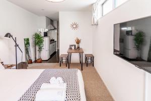 a bedroom with a bed and a table with chairs at 川HOUSE旭 in Osaka