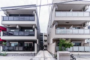 an apartment building with balconies and a courtyard at 川HOUSE旭 in Osaka
