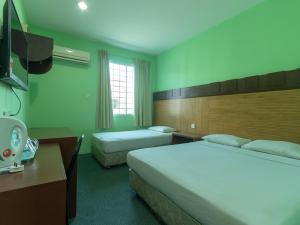 Postel nebo postele na pokoji v ubytování Royal Hotel