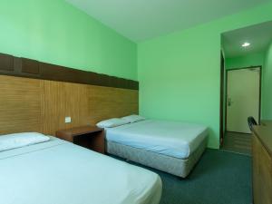 Postel nebo postele na pokoji v ubytování Royal Hotel