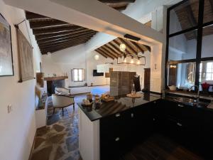 a room with a kitchen and a living room at Finca Altozano - Private pool in Valle de Abdalagís +22 photos