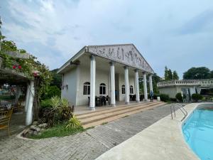 dom z basenem przed nim w obiekcie Torres Farm Resort powered by Cocotel w mieście Naic