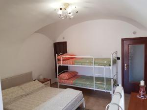 a room with two bunk beds and a table at La Tana degli Orsetti in Barrea