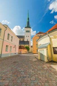a city street with a clock tower in the background at Rija Old Town Hotel in Tallinn