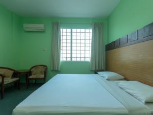Postel nebo postele na pokoji v ubytování Royal Hotel