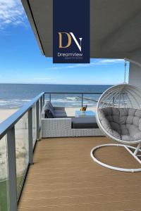 a balcony with a swing and the ocean at Apartament Dream View Gardenia Front in Dziwnów