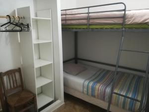 a bedroom with a bunk bed and a chair at Au pays du Ventoux in Le Thor