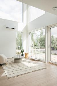 a living room with a large window and a coffee table at Lovely Scandinavian Duplex for 6 and babybed in Vantaa Hiekkaharju Tikkurila in Vantaa