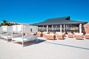 - un ensemble de chaises longues et de parasols sur la terrasse dans l'établissement Hotel Best Costa Ballena, à Costa Ballena