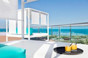 a table with two glasses of orange juice on a balcony at Hotel Best Costa Ballena in Costa Ballena +112 photos
