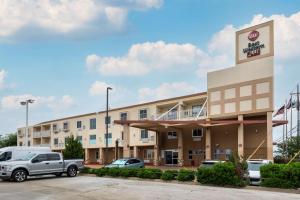 a hotel with a truck parked in a parking lot at Best Western PLUS Rockwall Inn & Suites in Rockwall