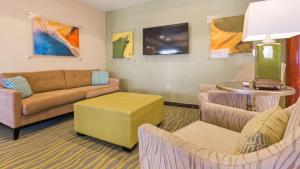 a living room with a couch and two chairs at Best Western Palace Inn & Suites in Big Spring