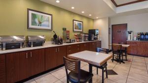 a waiting room with a table and a counter at Best Western Palace Inn & Suites in Big Spring