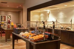 a buffet area of a hotel with food on a counter at Hilton Atlanta Northeast in Norcross