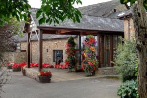 a house with flowers on the front of it at Garstang Country Hotel & Golf, Sure Hotel Collection in Garstang