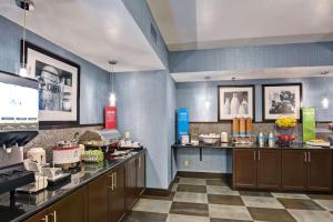 a restaurant kitchen with a counter top and a unintention at Hampton Inn State College in State College