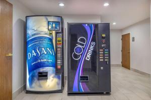 a drink vending machine with a bottle of water in it at Motel 6-Fort Worth, TX - Burleson in Fort Worth