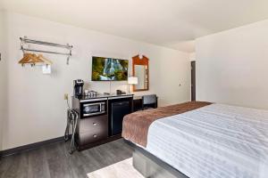 a hotel room with a bed and a tv at SureStay Hotel by Best Western Twin Falls in Twin Falls