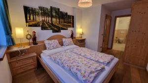 sypialnia z łóżkiem, biurkiem i obrazem w obiekcie Alex w mieście Campitello di Fassa