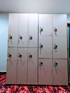 a locker room with four lockers in a room at 駿府城下町の宿　玉乃屋 in Shizuoka