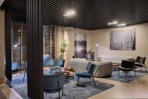 a waiting area with chairs and a waiting room at Radisson Blu Hotel Milan in Milan +167 photos