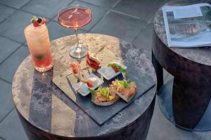 a table with a plate of food and a drink at Radisson Blu Hotel Milan in Milan