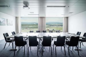 ein großer Tagungsraum mit einem großen Tisch und Stühlen in der Unterkunft Radisson Blu Hotel Zurich Airport in Kloten