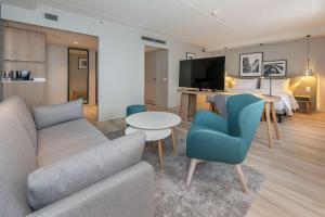 a living room with a couch and a table at Radisson Hotel Kaunas in Kaunas