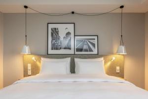 a bedroom with a large bed with two white pillows at Radisson Hotel Kaunas in Kaunas